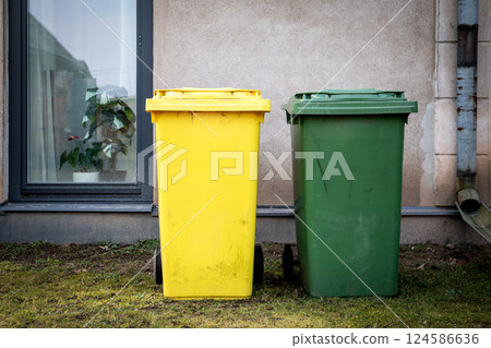 Yellow and Green Trash Bins Next to Building Yellow and Green Trash Bins Next to Building 124586636