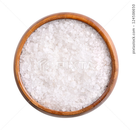 Coarse Dead Sea salt in wooden bowl, isolated, from above. Crystalized salt extracted from the Dead Sea, rich in chloride, magnesium, sodium, calcium and potassium. Used as bath salt and in cosmetics. 124586650