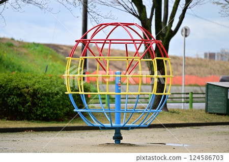 Spinning play equipment in the park 124586703