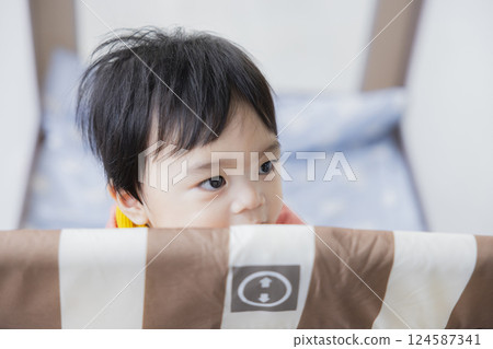 Baby in a crib 124587341