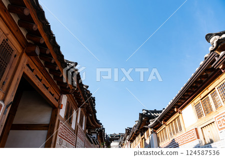 Looking up the hill at Bukchon Hanok Village, near Anguk Station, spring blue sky, Seoul, Korea Looking up the hill at Bukchon Hanok Village, near Anguk Station, spring blue sky, Seoul, Korea 124587536