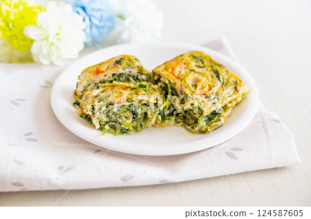Rolled egg with mekabu, crab sticks and pea sprouts 124587605