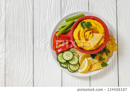creamy roast carrot hummus in red bowl creamy roast carrot hummus in red bowl 124588187