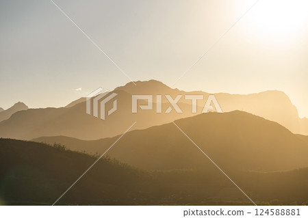 Mountains silhouettes in sun light. Natural landscape 124588881