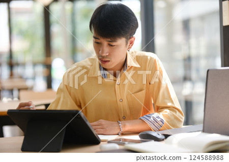 University student studying online and preparing for exams. University student studying online and preparing for exams. 124588988