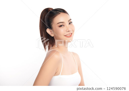 A beautiful young Asian woman with clean, fresh skin against a white background. Skincare, facial treatment, cosmetology, beauty, and spa. An elegant portrait of an Asian woman. 124590076