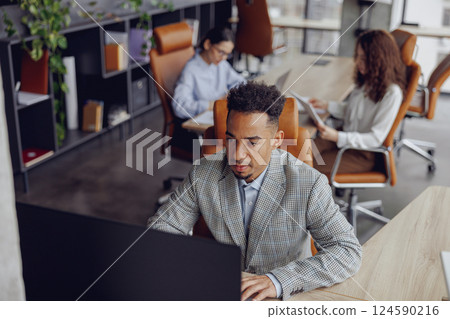 A modern workspace featuring professionals actively engaged in collaborative and innovative work A modern workspace featuring professionals actively engaged in collaborative and innovative work 124590216