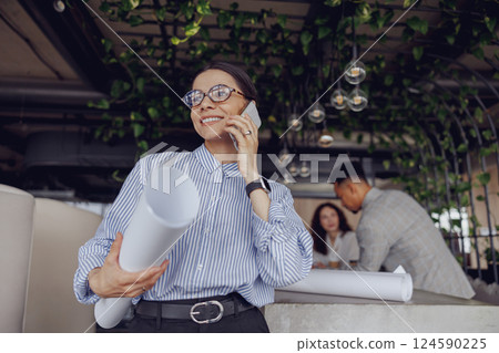 A professional woman engaging in a detailed discussion about future plans in a modern office space A professional woman engaging in a detailed discussion about future plans in a modern office space 124590225