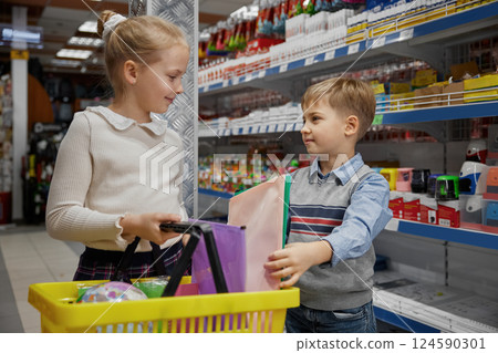 Little sister and brother enjoying fun shopping time preparing to school Little sister and brother enjoying fun shopping time preparing to school 124590301