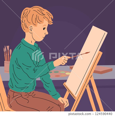 Boy paints a picture on canvas Boy paints a picture on canvas 124590440