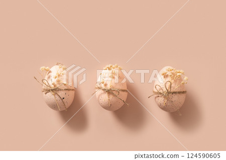 Easter chicken pink eggs decorated white gypsophila flowers on pink background. View from above. 124590605