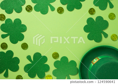 St Patricks day frame with leprechaun hat and clover leaves on green background. St Patricks day frame with leprechaun hat and clover leaves on green background. 124590641