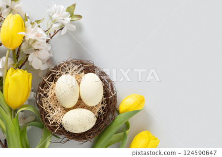 Easter eggs in nest on gray background. 124590647