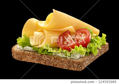 Cheese sandwich with lettuce and tomato on bread isolated on black background Cheese sandwich with lettuce and tomato on bread isolated on black background 124591089