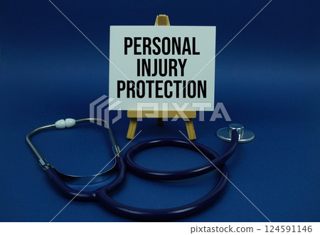 Personal Injury Protection text message on paper card with stethoscope on wooden background Personal Injury Protection text message on paper card with stethoscope on wooden background 124591146