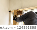 Carpenter doing interior construction work 124591868