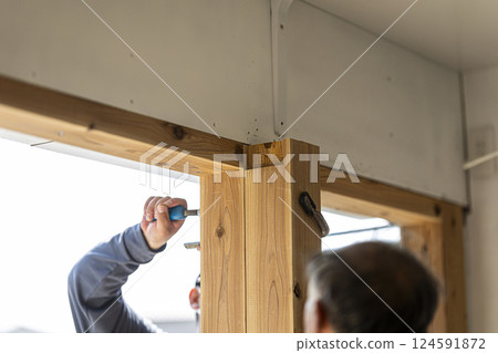 Carpenter doing interior construction work Carpenter doing interior construction work 124591872