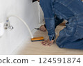 Carpenter doing interior construction work 124591874