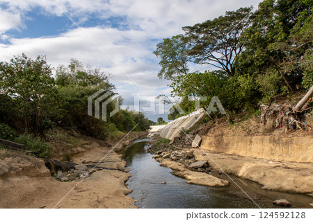 The riverbank of Ylang Ylang River in Cavite, Philippines at a low water level The riverbank of Ylang Ylang River in Cavite, Philippines at a low water level 124592128