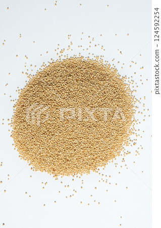 Pile of raw organic amaranth grains on a white background, top view 124592254