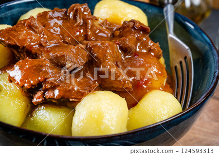 Beef stew in gravy, served with silesian dumplings. 124593313