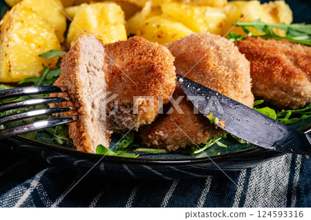 Meatballs with cheese served with boiled potatoes. 124593316