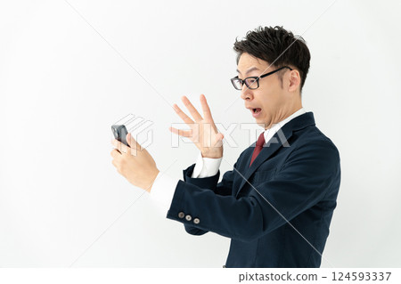 Businessman looking at a smartphone Businessman looking at a smartphone 124593337