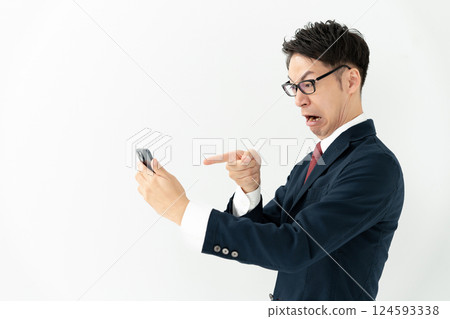 Businessman looking at a smartphone Businessman looking at a smartphone 124593338