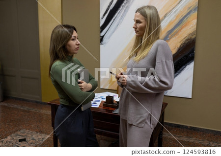 Conversation between two women in a modern office setting during a business meeting Conversation between two women in a modern office setting during a business meeting 124593816