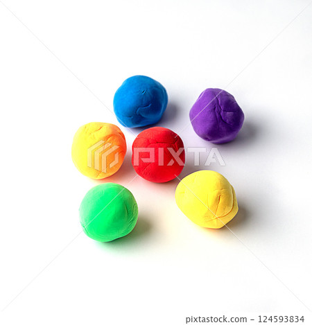 Colorful modeling clay spheres arranged on a white background 124593834