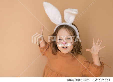 A lovely little girl in the guise of a rabbit. Easter surprise A lovely little girl in the guise of a rabbit. Easter surprise 124593863