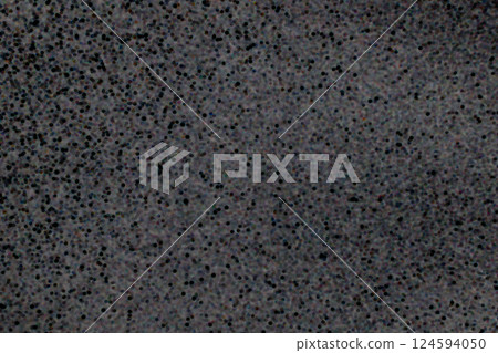 Closeup view of black dotted texture on a dark gray surface background Closeup view of black dotted texture on a dark gray surface background 124594050