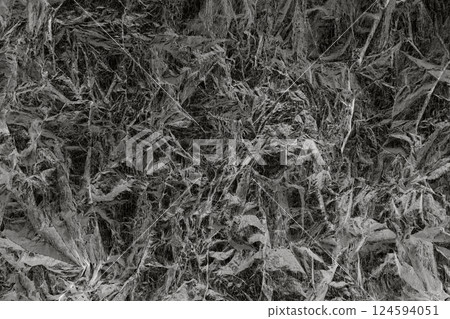 Abstract textured pattern resembling crumpled paper in monochrome tones 124594051