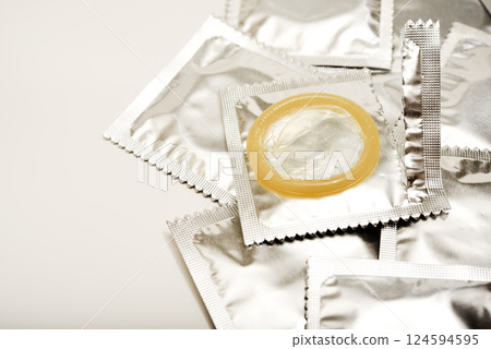 An open condom in a package. Male contraceptives. An open condom in a package. Male contraceptives. 124594595