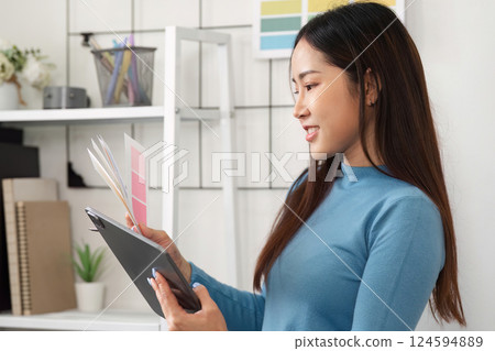 Artistic Color Exploration. A designer thoughtfully reviewing color options with enthusiasm. 124594889