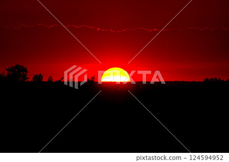 Spectacular sunset with big round sun and red sky. Spectacular sunset with big round sun and red sky. 124594952