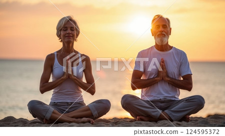A elderly couple practicing meditation near the ocean 124595372