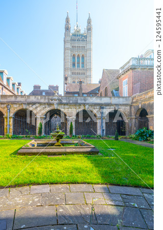 Visitors can stroll through the serene green lawn of the Cloisters at Westminster Abbey in London. Captivating architecture and historical significance enhance the tranquil atmosphere. Visitors can stroll through the serene green lawn of the Cloisters at Westminster Abbey in London. Captivating architecture and historical significance enhance the tranquil atmosphere. 124595441