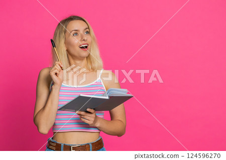 Woman making notes writing down thoughts with pen into notepad notebook diary to do list good idea Woman making notes writing down thoughts with pen into notepad notebook diary to do list good idea 124596270