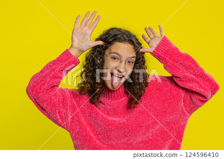 Cheerful funny bully girl showing tongue making silly faces, fooling around joking teasing Cheerful funny bully girl showing tongue making silly faces, fooling around joking teasing 124596410