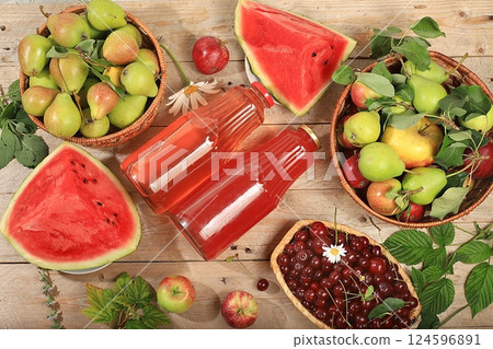 Apple, pear, cherry cider, juice or fruit drink in bottles on a wooden table. The concept of diet and weight loss. Apples help cleanse the body and reduce weight. Healthy food, selective focus Apple, pear, cherry cider, juice or fruit drink in bottles on a wooden table. The concept of diet and weight loss. Apples help cleanse the body and reduce weight. Healthy food, selective focus 124596891