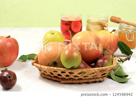 Apple and pear cider, juice or fruit drink and ingredients on a sunny table. The concept of diet and weight loss. Apples help cleanse the body and reduce weight. Healthy eating, body detoxification Apple and pear cider, juice or fruit drink and ingredients on a sunny table. The concept of diet and weight loss. Apples help cleanse the body and reduce weight. Healthy eating, body detoxification 124596942