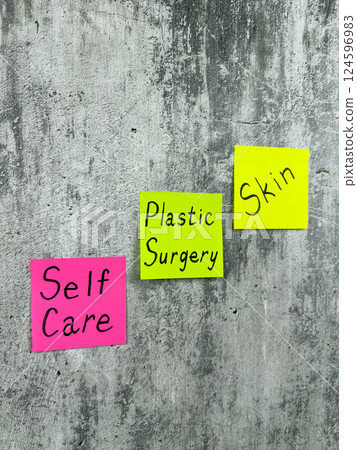 Vertical photo of sticky notes with words reminding about skin care. Use plastic surgery for health and skin improvement. Simple concept of selfcare Vertical photo of sticky notes with words reminding about skin care. Use plastic surgery for health and skin improvement. Simple concept of selfcare 124596983