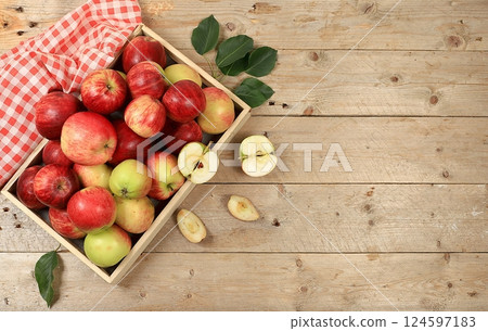 Autumn composition of apples in a box on a sunny wooden table, thanksgiving background, harvest, healthy natural food concept, detox diet and body cleansing, screen banner, cafe, restaurant, selective Autumn composition of apples in a box on a sunny wooden table, thanksgiving background, harvest, healthy natural food concept, detox diet and body cleansing, screen banner, cafe, restaurant, selective 124597183