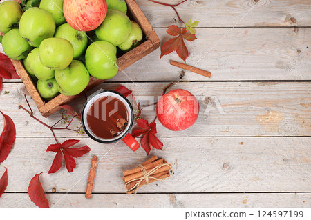 Apple cider, juice or fruit drink and ingredients on a sunny table. The concept of diet and weight loss. Apples help cleanse the body and reduce weight. Healthy eating, body detoxification Apple cider, juice or fruit drink and ingredients on a sunny table. The concept of diet and weight loss. Apples help cleanse the body and reduce weight. Healthy eating, body detoxification 124597199