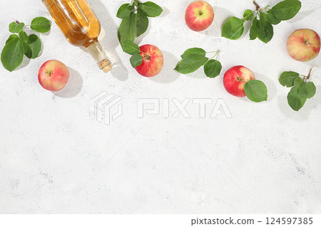 Apple cider drink, juice or fermented fruit drink and ingredients on a sunny table. Autumn banner. The concept of diet and weight loss. Healthy eating, body detoxification, apples help cleanse the Apple cider drink, juice or fermented fruit drink and ingredients on a sunny table. Autumn banner. The concept of diet and weight loss. Healthy eating, body detoxification, apples help cleanse the 124597385
