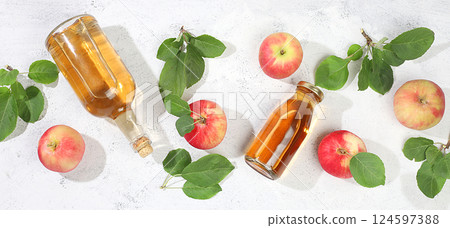 Autumn banner.Apple cider, juice or fruit drink and ingredients on a sunny table. The concept of diet and weight loss. Apples help cleanse the body and reduce weight. Healthy food, body Autumn banner.Apple cider, juice or fruit drink and ingredients on a sunny table. The concept of diet and weight loss. Apples help cleanse the body and reduce weight. Healthy food, body 124597388