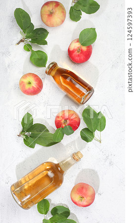 Apple cider, juice or fruit drink and ingredients on a sunny table. The concept of diet and weight loss. Apples help cleanse the body and reduce weight. Healthy food, body detoxification, selective Apple cider, juice or fruit drink and ingredients on a sunny table. The concept of diet and weight loss. Apples help cleanse the body and reduce weight. Healthy food, body detoxification, selective 124597393