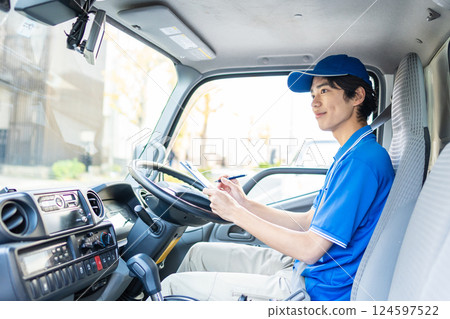Young delivery staff driving Young delivery staff driving 124597522