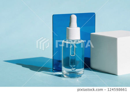 Dropper Bottle with white Cap on Light Blue Background 124598661